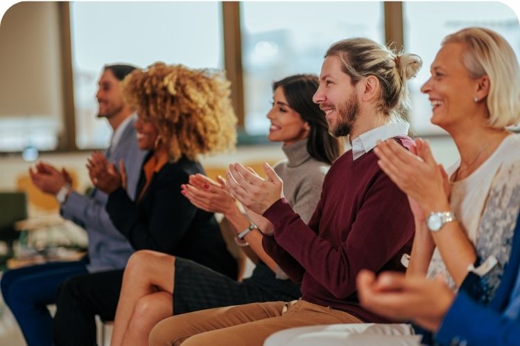 An audience clapping for the speaker.