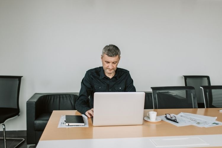 Business man working alone at a conference table.