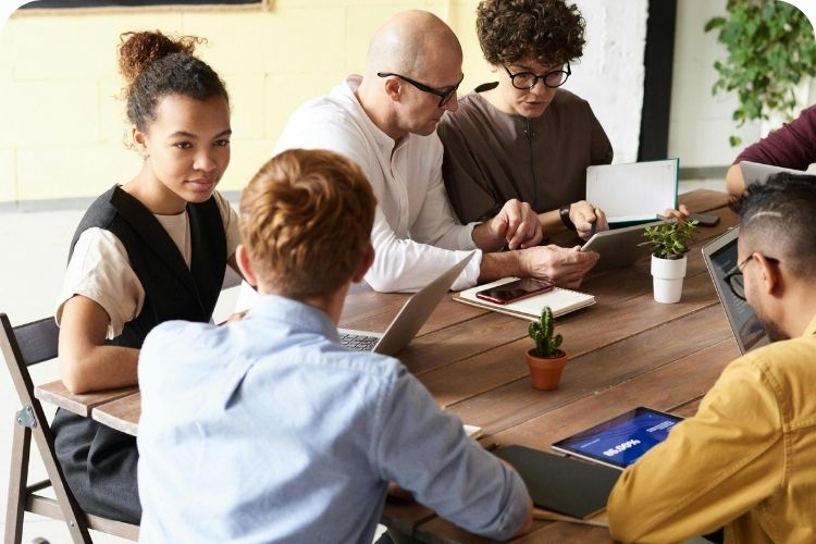 A church staff meeting around a table.