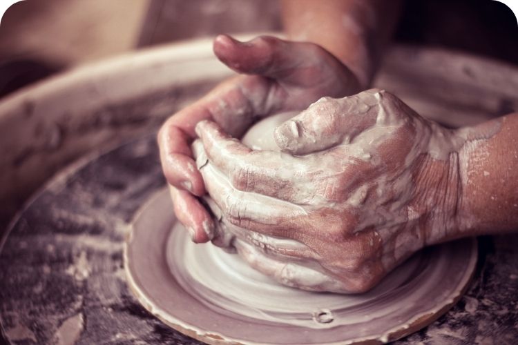 Potter forming clay.
