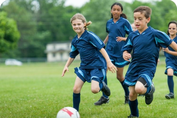 Kids playing soccer.