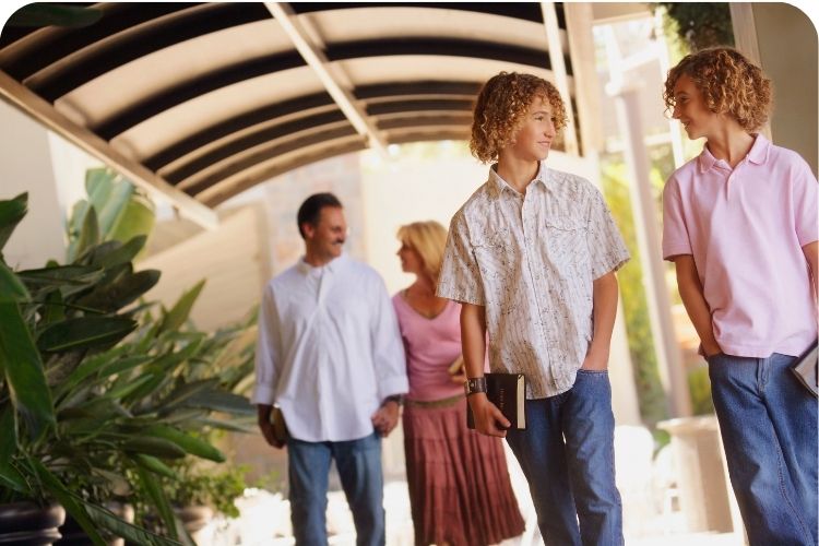 A family going to church, all holding their Bibles.