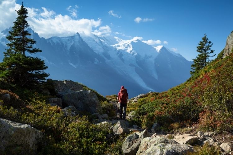 A man on a grand hike in the mountains.