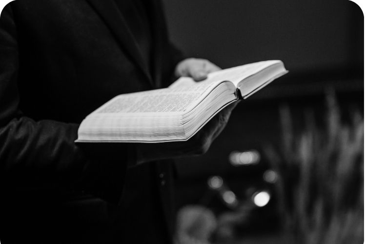 A man holding an open Bible.