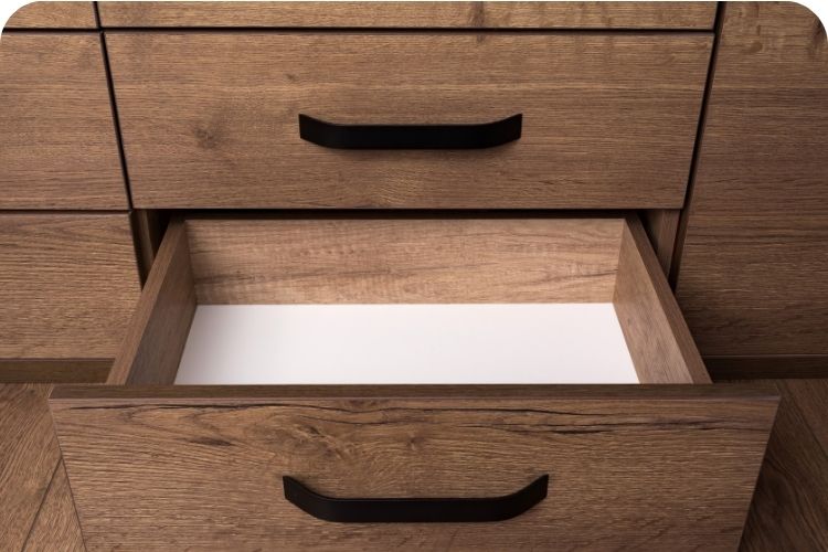 A dresser with one drawer pulled open.