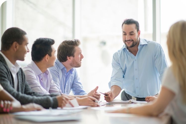 A confident leader leading a team meeting.