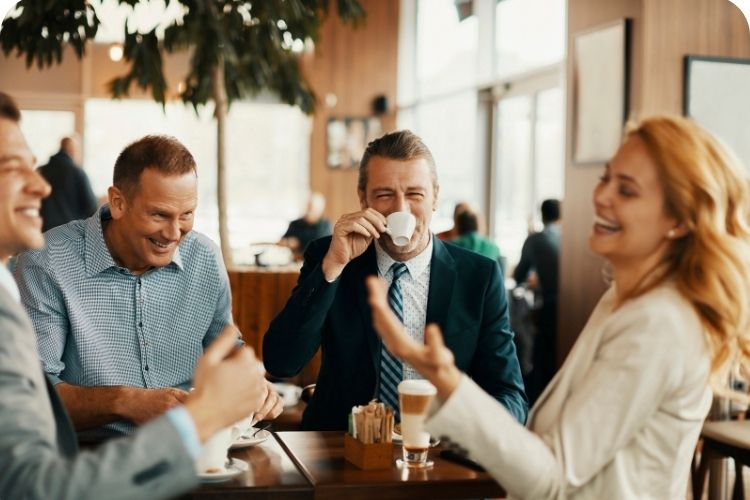 A group of coworkers having fun socializing over coffee.