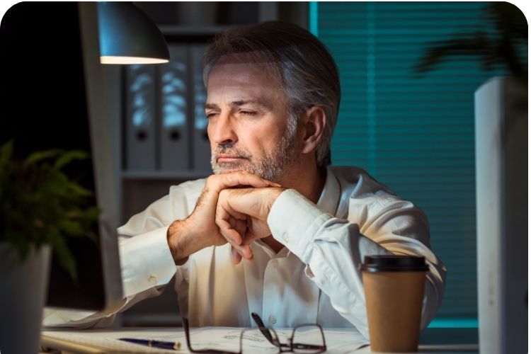 A tired man working late at night.