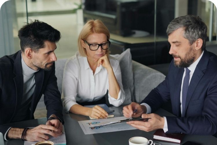 A team of three discussing business strategy.