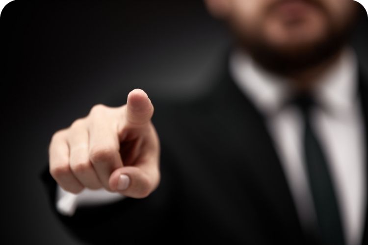 A business leader pointing his finger at someone.