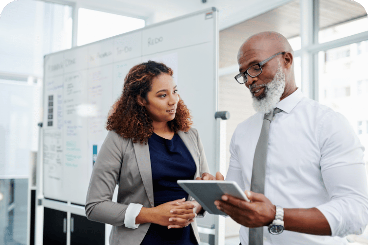 A boss with an attentive employee right beside him.