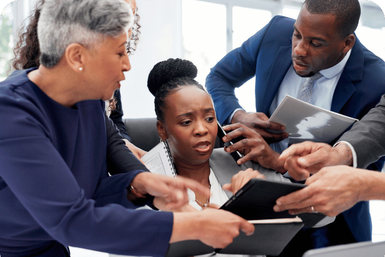 An executive surrounded by employees who need her.