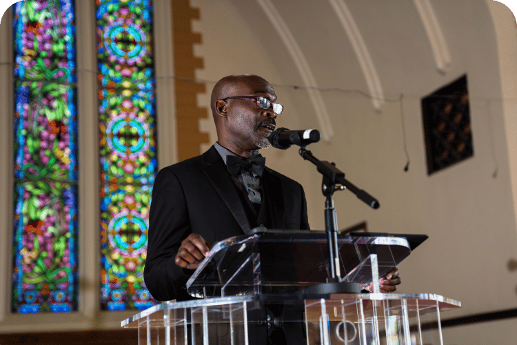 An elder pastor preaching.
